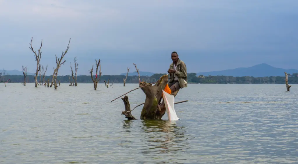 Lake Naivasha - Man Fishing from a Dead Tree
