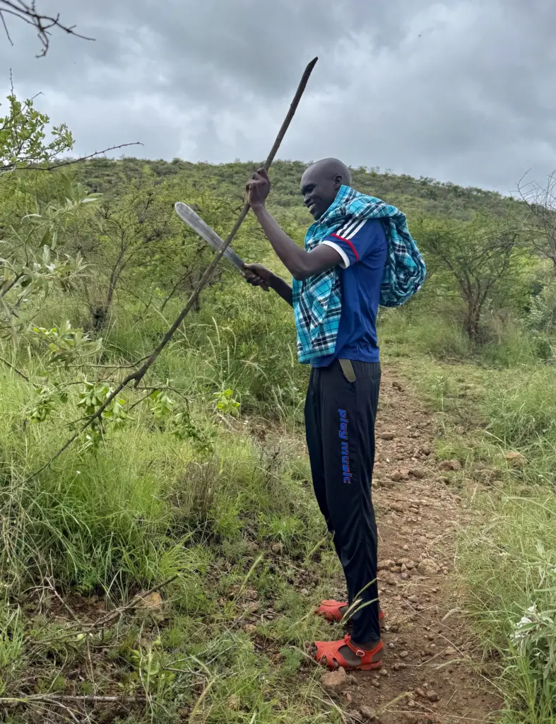 Mount Olorruka - John the Guide Cutting a Walking Stick